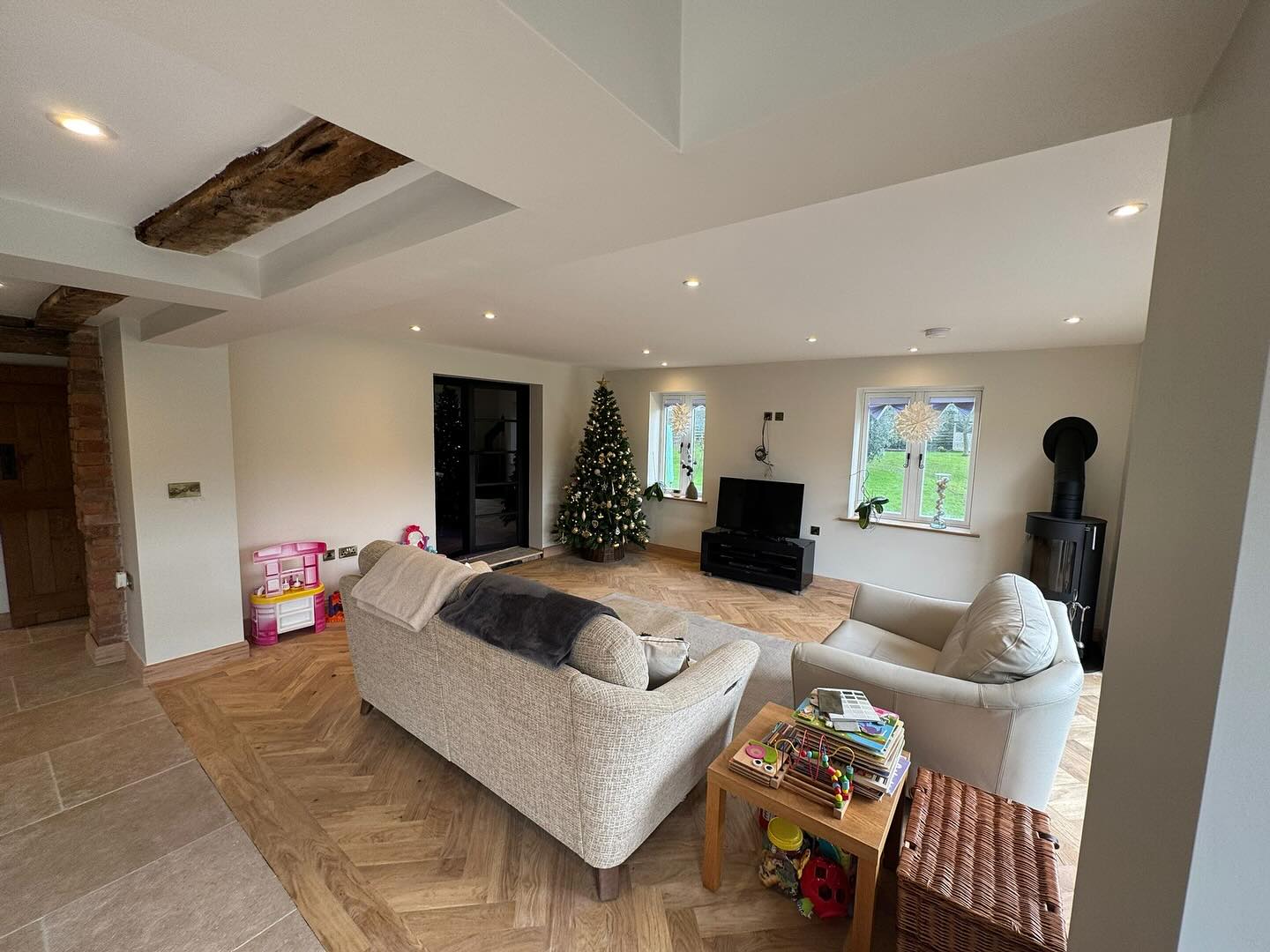 Open-plan lounge with freshly painted walls and exposed beams