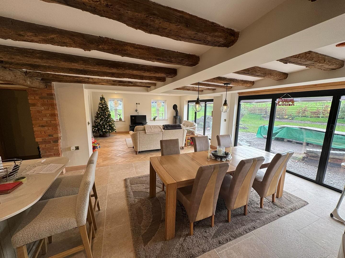 Kitchen diner with a beamed ceiling and bi-fold doors