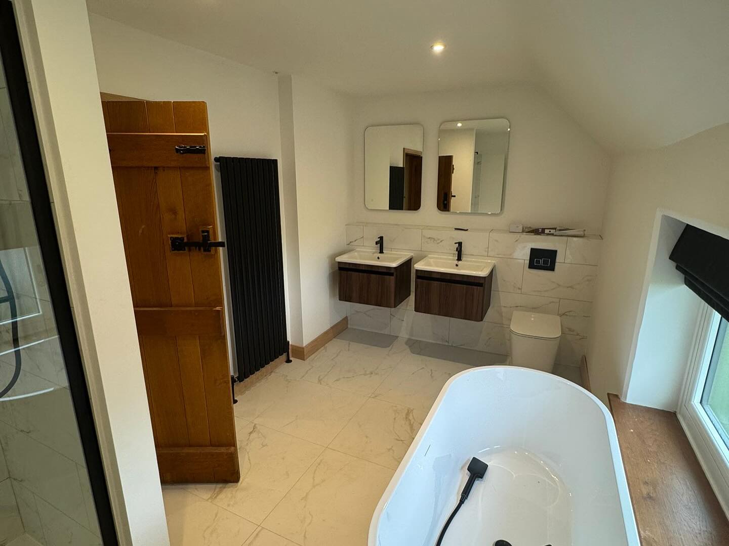 Bathroom with a freestanding bath and fresh white walls